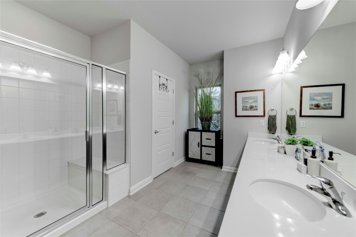 13800 Lyndhurst Street, Unit 125 Austin, TX 78717 - Photo 23 of 27 a spacious bathroom with a tub shower and mirror
