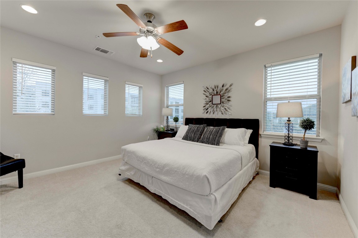 13800 Lyndhurst Street, Unit 125 Austin, TX 78717 - Photo 4 of 27 a spacious bedroom with a large bed and a chandelier