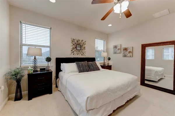 a bedroom with a bed and a painting on the wall