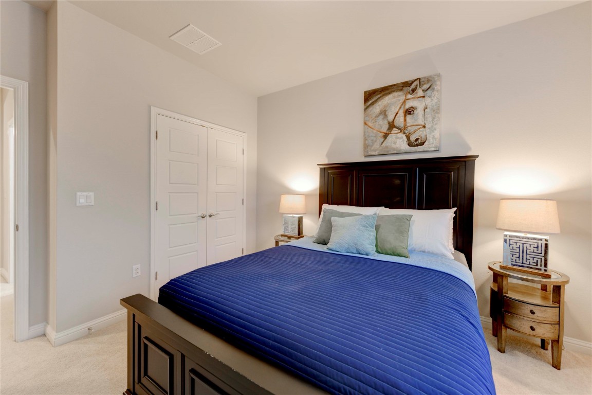 13800 Lyndhurst Street, Unit 125 Austin, TX 78717 - Photo 6 of 27 a bedroom with a bed and paintings on the wall