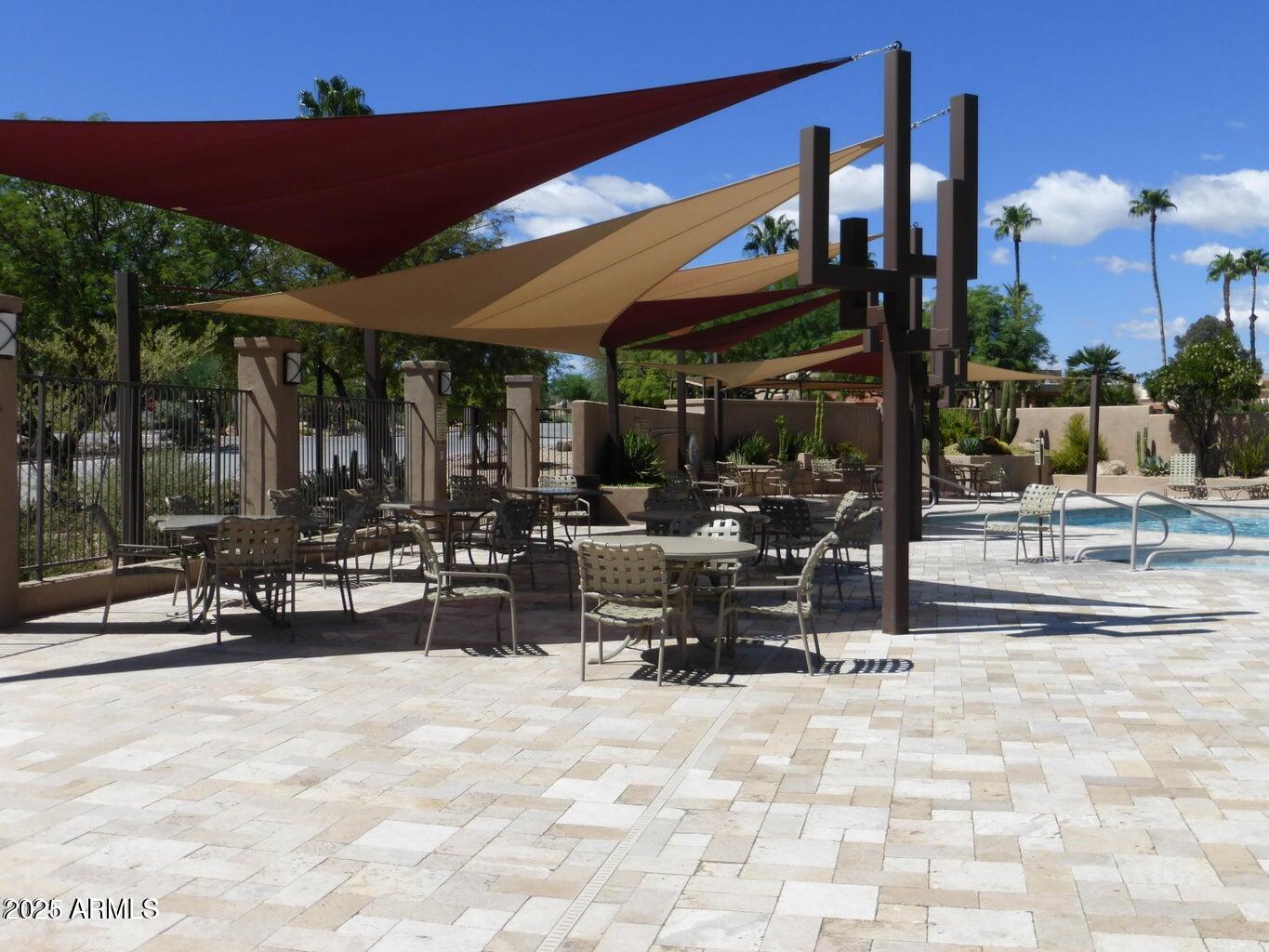 25621 North Sago Drive Rio Verde, AZ 85263 - Photo 43 of 45 a view of a patio with a table and chairs under an umbrella