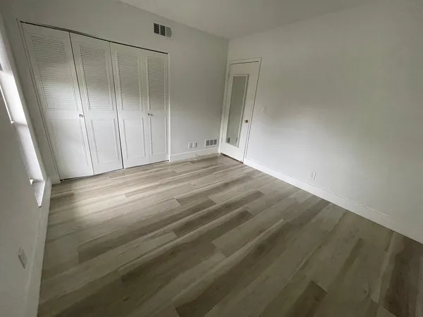a view of room with wooden floor