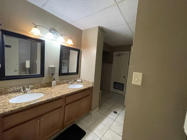a kitchen with granite countertop wooden cabinets a sink and stainless steel appliances