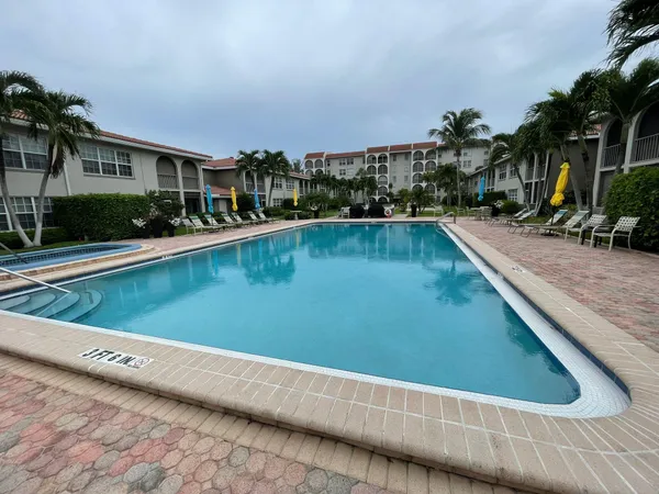 a view of a swimming pool with outdoor seating