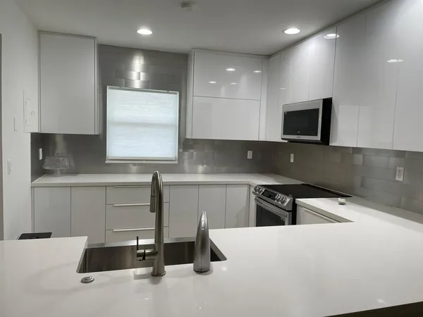 a kitchen that has a sink and a stove in it