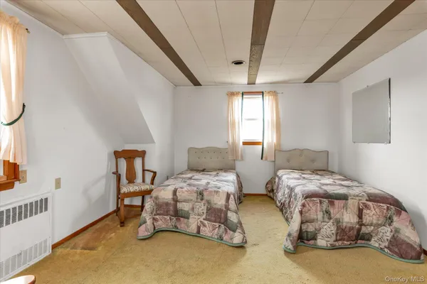 a bedroom with two beds and a window
