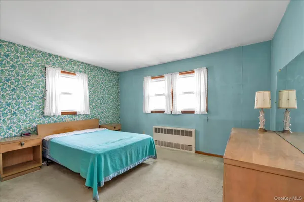 a bedroom with a bed and windows