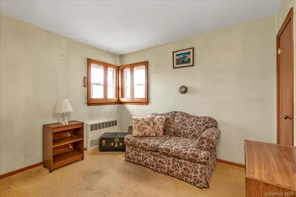 a living room with furniture a couch and a window