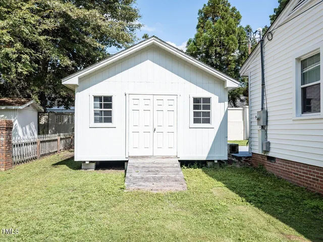 a hallway with a black white checkered floor and a large window