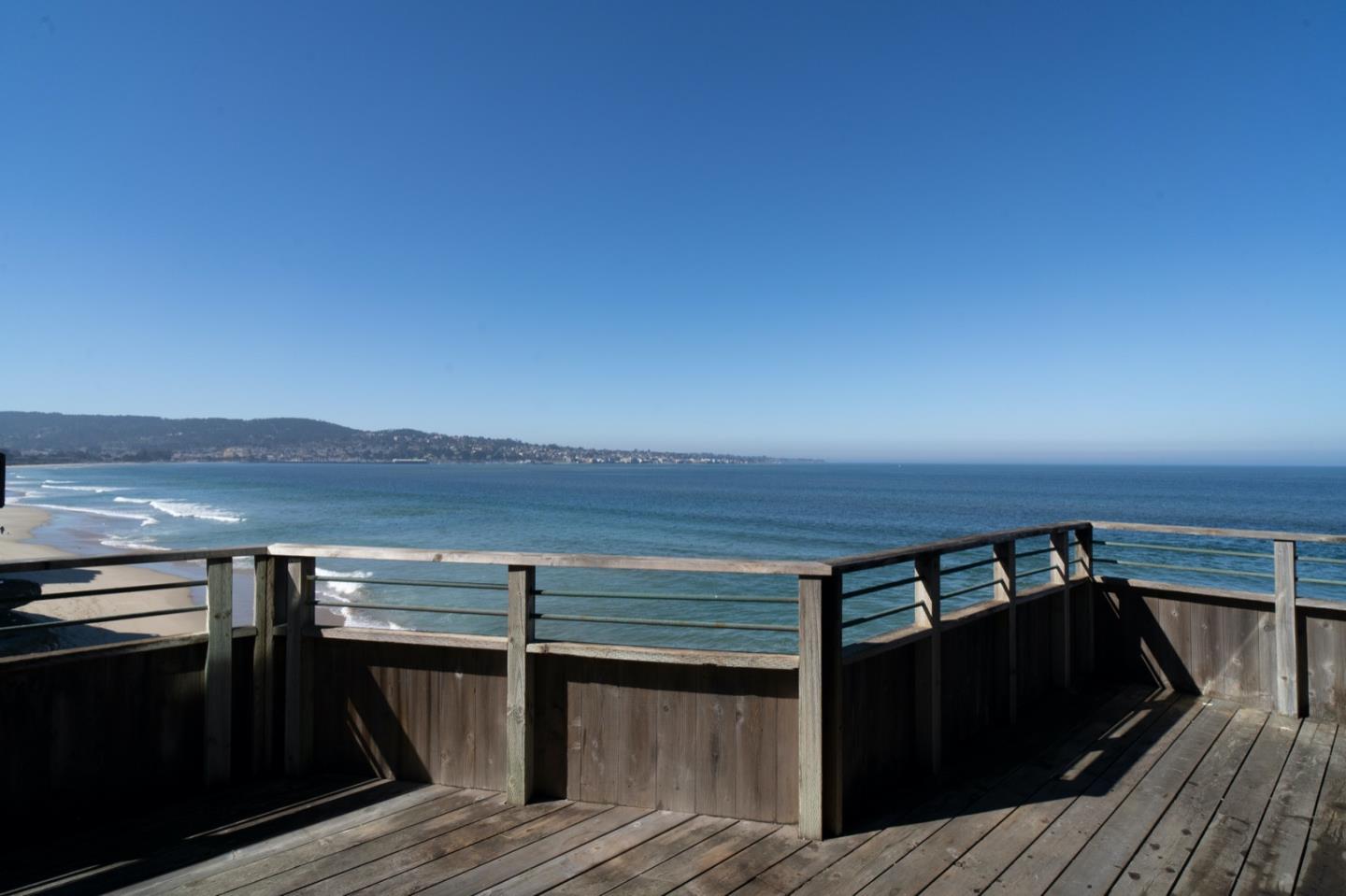 1 Surf Way, Unit 240 Monterey, CA 93940 - Photo 2 of 29 a view of a balcony with wooden floor and city view
