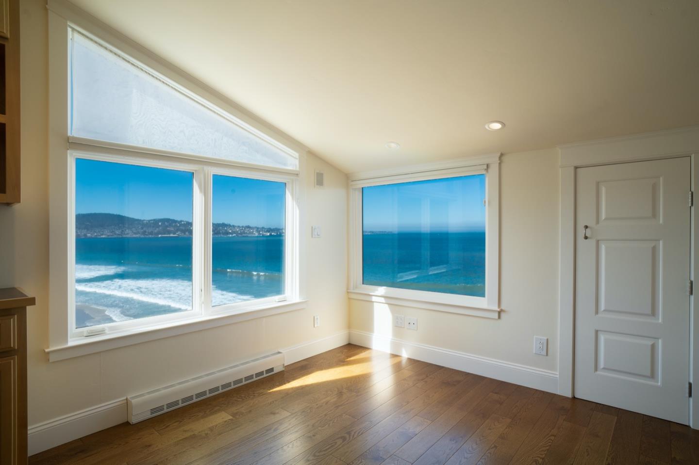 1 Surf Way, Unit 240 Monterey, CA 93940 - Photo 15 of 29 an empty room with wooden floor and windows
