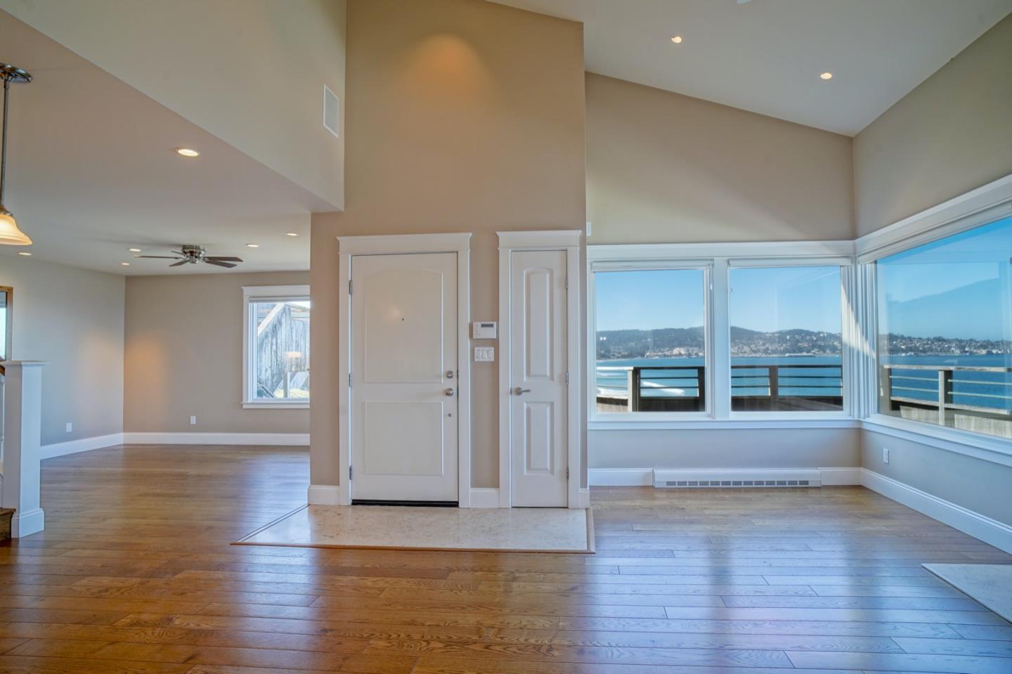 1 Surf Way, Unit 240 Monterey, CA 93940 - Photo 3 of 29 an empty room with wooden floor and windows