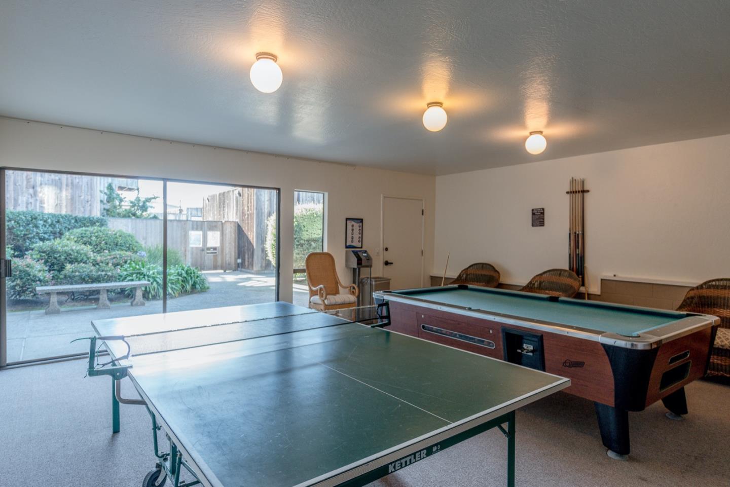 1 Surf Way, Unit 240 Monterey, CA 93940 - Photo 27 of 29 a room with pool table and windows