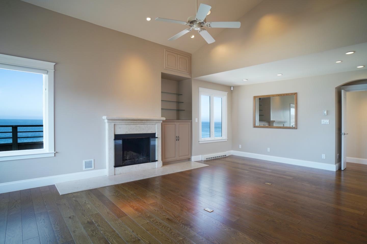 1 Surf Way, Unit 240 Monterey, CA 93940 - Photo 4 of 29 a view of an empty room with a window and wooden floor