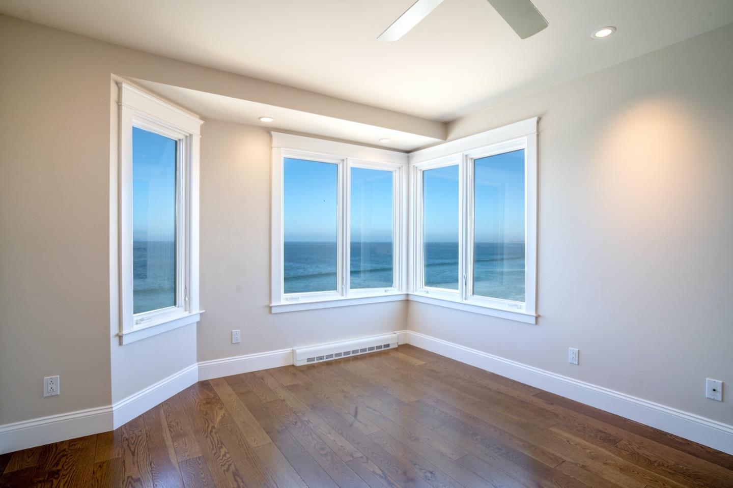1 Surf Way, Unit 240 Monterey, CA 93940 - Photo 8 of 29 an empty room with wooden floor and windows