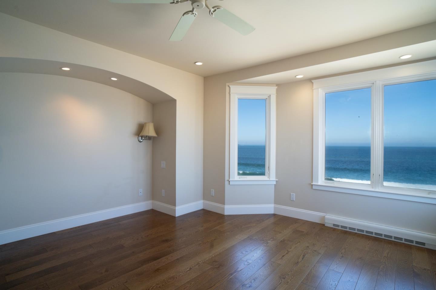 1 Surf Way, Unit 240 Monterey, CA 93940 - Photo 9 of 29 a view of an empty room with wooden floor and a window