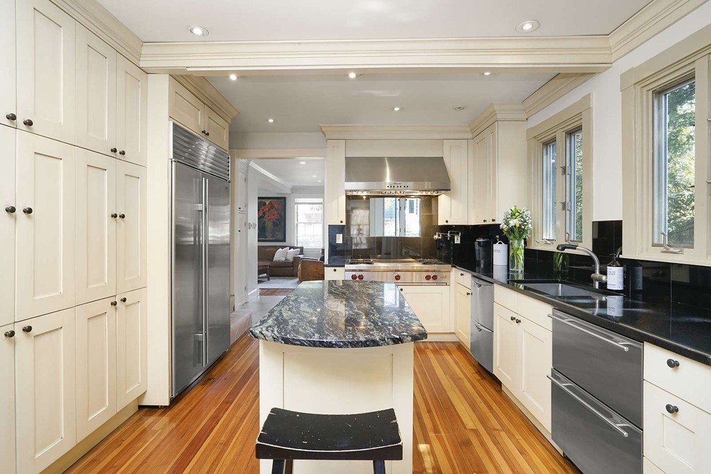 173 School Street Milton, MA 02186 - Photo 11 of 30 a large kitchen with a center island wooden floor and stainless steel appliances