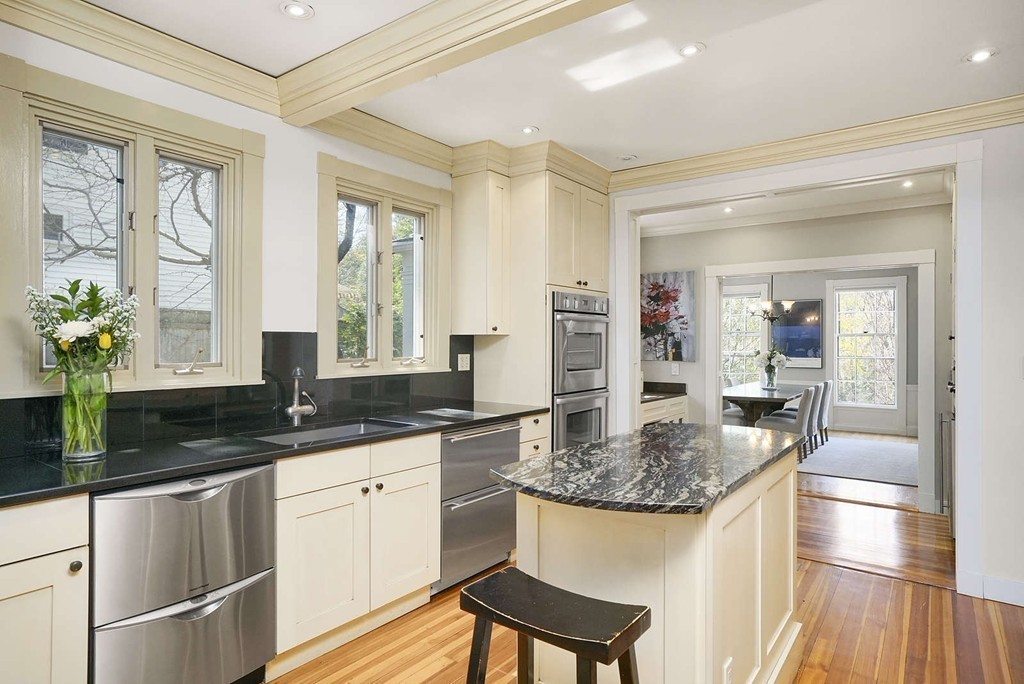 173 School Street Milton, MA 02186 - Photo 14 of 30 a kitchen with granite countertop a sink and a refrigerator