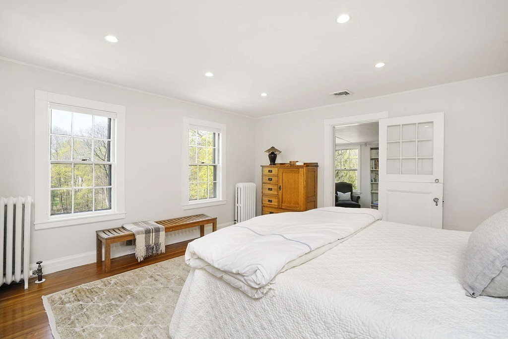 173 School Street Milton, MA 02186 - Photo 17 of 30 a spacious bedroom with a large bed and a dresser