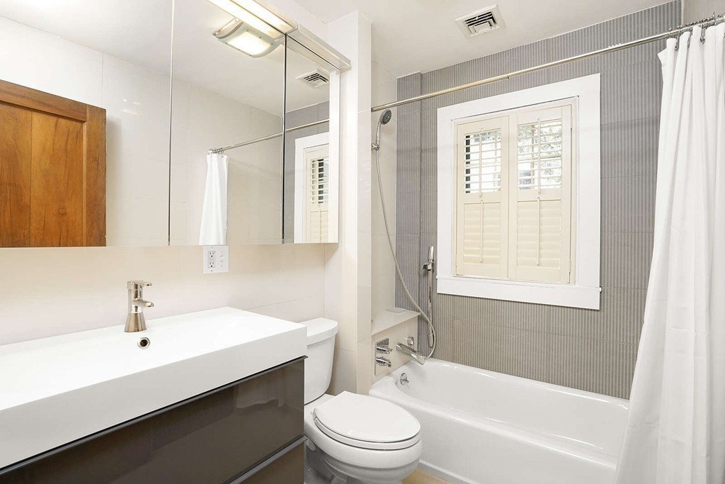 173 School Street Milton, MA 02186 - Photo 23 of 30 a bathroom with a sink a toilet and shower