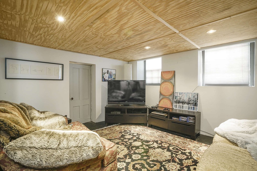 173 School Street Milton, MA 02186 - Photo 25 of 30 a living room with a bed and furniture