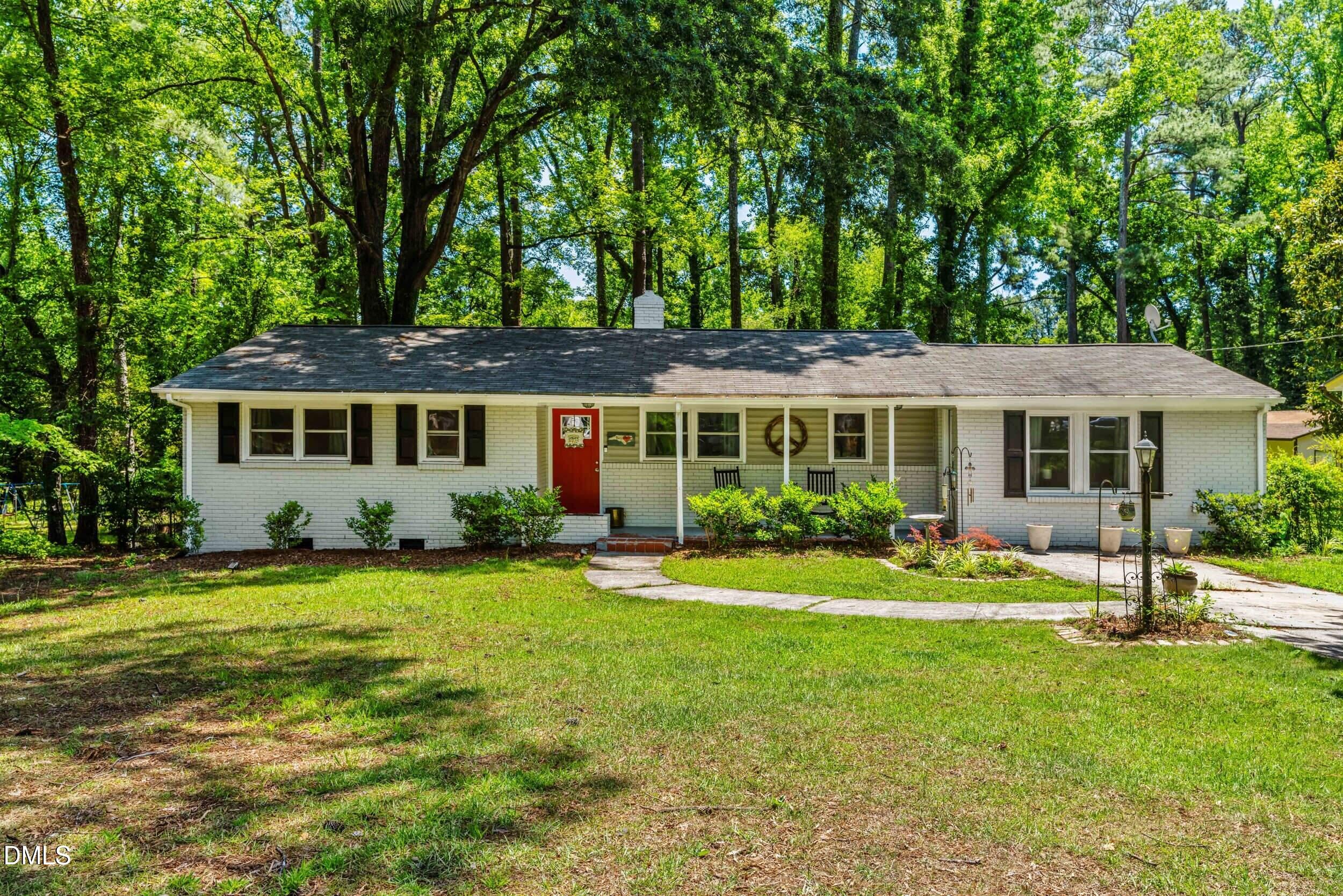 3724 Randell Road Garner, NC 27529 - Photo 4 of 32 a front view of a house with a garden
