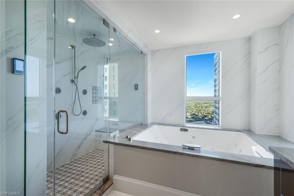 285 Grande Way, Unit 1006 Naples, FL 34110 - Photo 11 of 46 a bathroom with a granite countertop sink a shower and a mirror