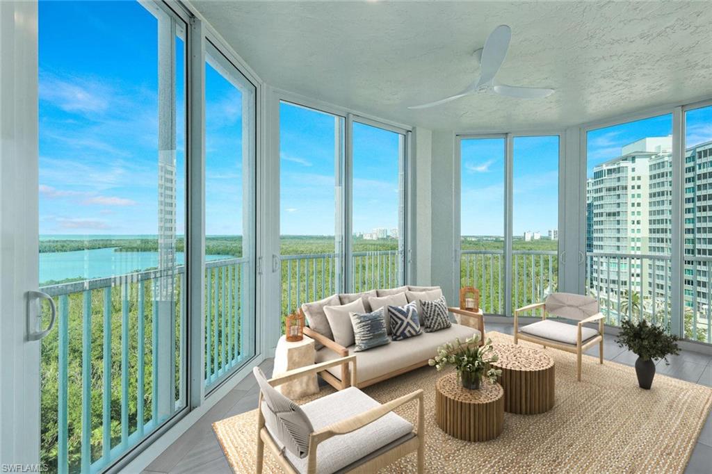 285 Grande Way, Unit 1006 Naples, FL 34110 - Photo 18 of 46 a living room with furniture and floor to ceiling windows