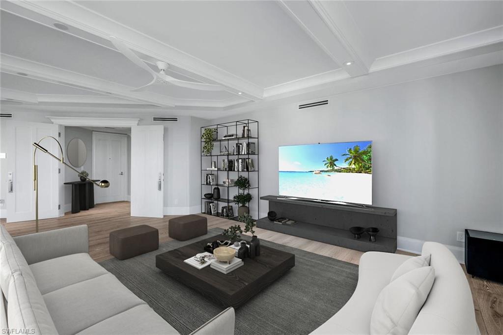 285 Grande Way, Unit 1006 Naples, FL 34110 - Photo 2 of 46 a living room with furniture a rug and a flat screen tv