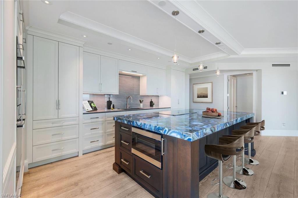 285 Grande Way, Unit 1006 Naples, FL 34110 - Photo 4 of 46 a kitchen with stainless steel appliances granite countertop stove top oven and cabinets