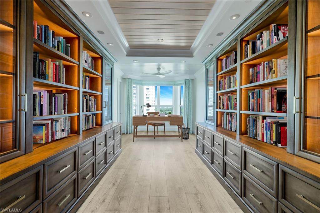 285 Grande Way, Unit 1006 Naples, FL 34110 - Photo 6 of 46 a room with lots of books