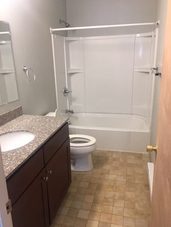 4 Providence Road Sutton, MA 01590 - Photo 13 of 14 a bathroom with a granite countertop sink a toilet and shower