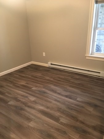 4 Providence Road Sutton, MA 01590 - Photo 7 of 14 a view of an empty room with wooden floor and a window
