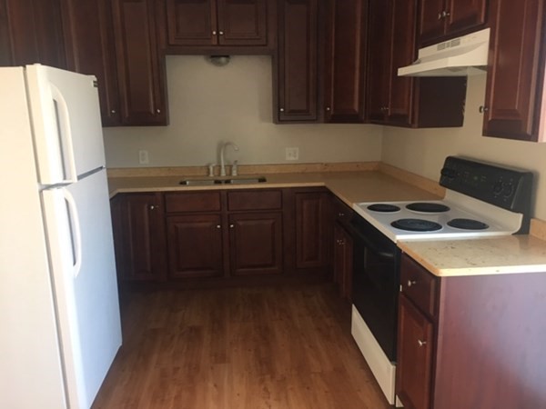 4 Providence Road Sutton, MA 01590 - Photo 10 of 14 a kitchen with stainless steel appliances granite countertop a refrigerator a stove a sink and dishwasher with wooden floor