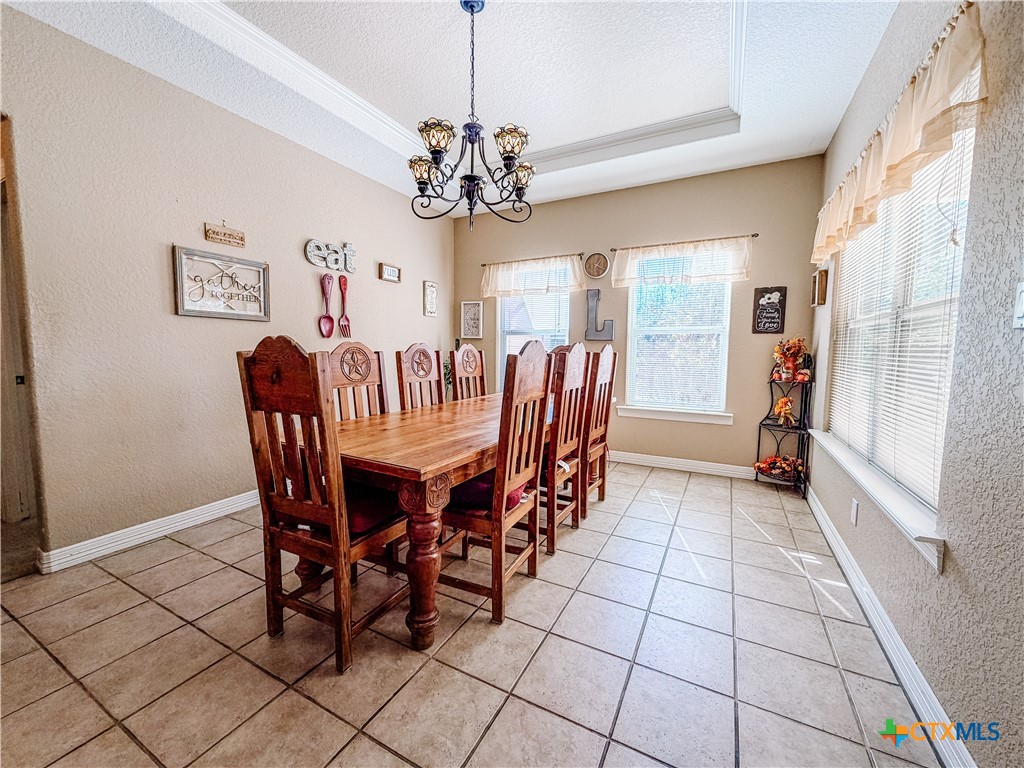 1027 Stagecoach Trail San Marcos, TX 78666 - Photo 11 of 36 a view of a dining room with furniture a chandelier and window