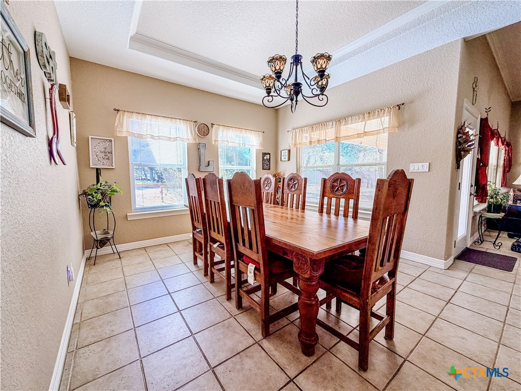1027 Stagecoach Trail San Marcos, TX 78666 - Photo 12 of 36 a view of a dining room with furniture and a chandelier