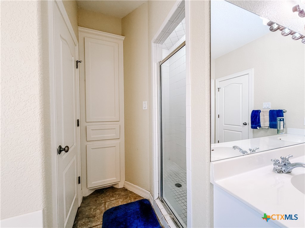 1027 Stagecoach Trail San Marcos, TX 78666 - Photo 18 of 36 a bathroom with a sink and a mirror
