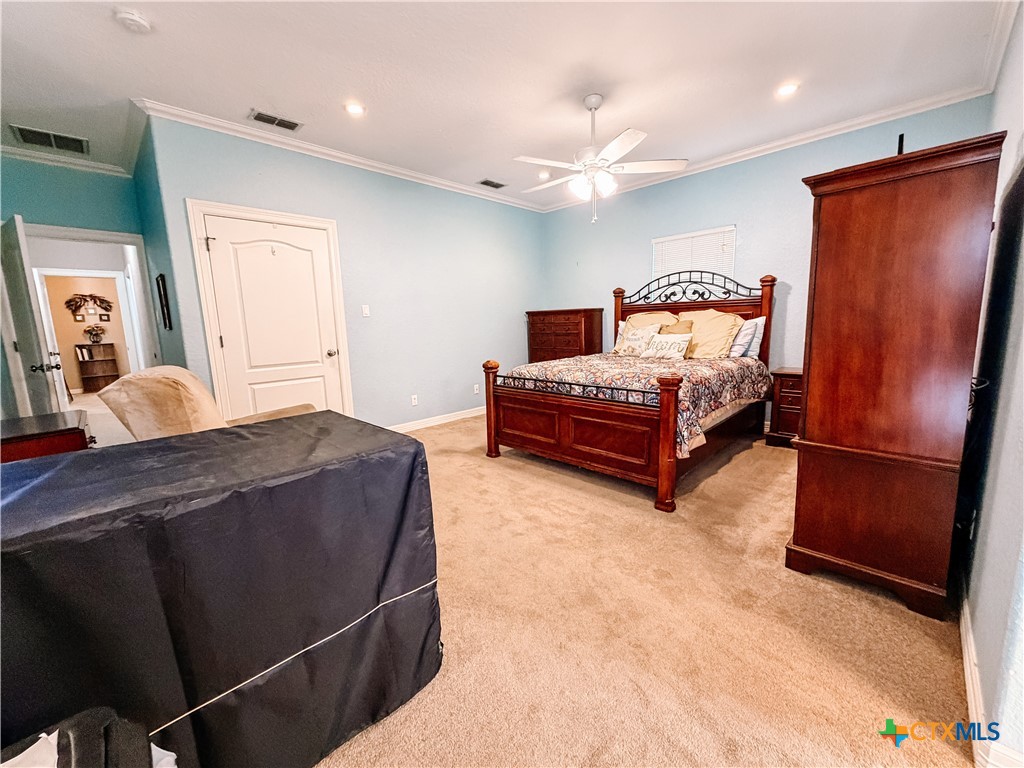 1027 Stagecoach Trail San Marcos, TX 78666 - Photo 23 of 36 a spacious bedroom with a bed and a refrigerator