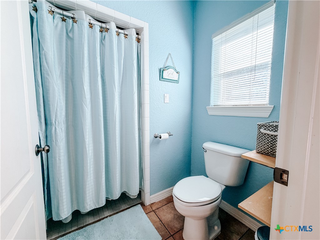 1027 Stagecoach Trail San Marcos, TX 78666 - Photo 27 of 36 a white toilet sitting next to a bathroom sink