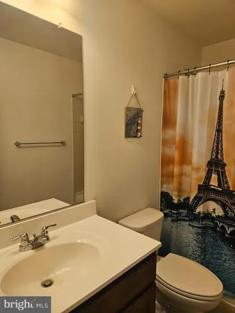 a bathroom with a sink toilet and mirror