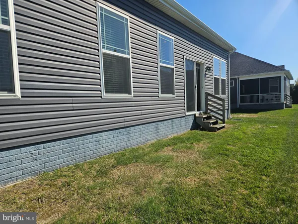 a view of a house with a yard and a large window