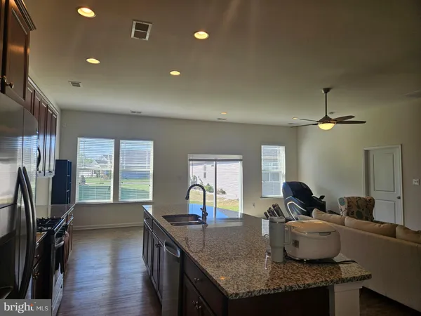 a kitchen with granite countertop a stove and a sink
