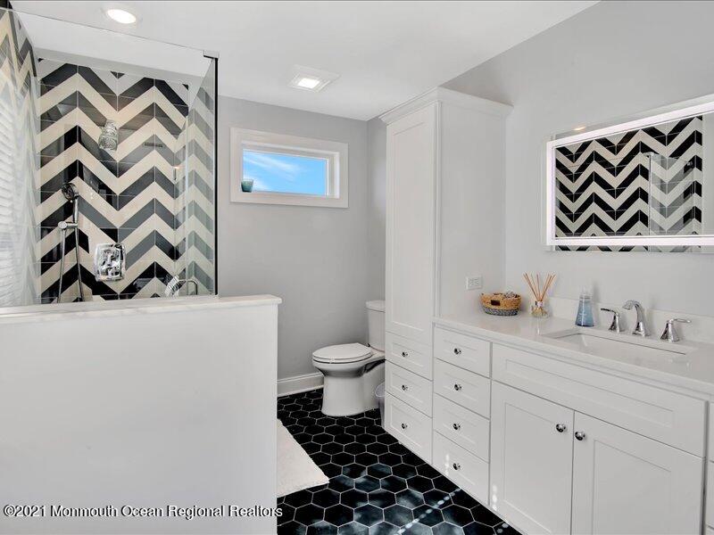 401 8th Avenue Seaside Heights, NJ 08751 - Photo 15 of 45 a bathroom with a toilet sink and mirror