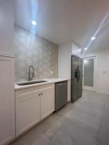a kitchen with a sink and refrigerator
