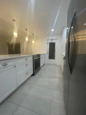 a large bathroom with a large mirror vanity and shower