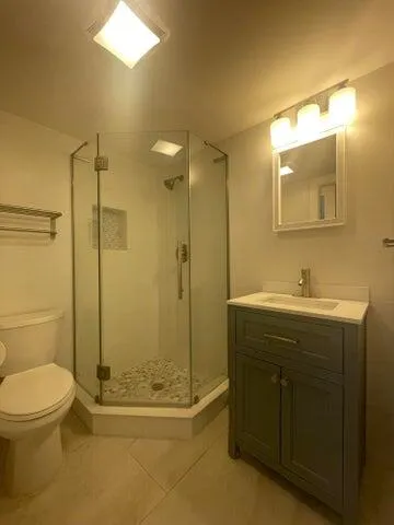 an empty room with a ceiling fan and windows