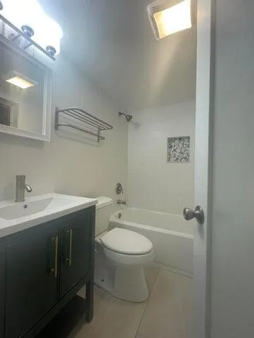 a bathroom with a sink vanity and toilet