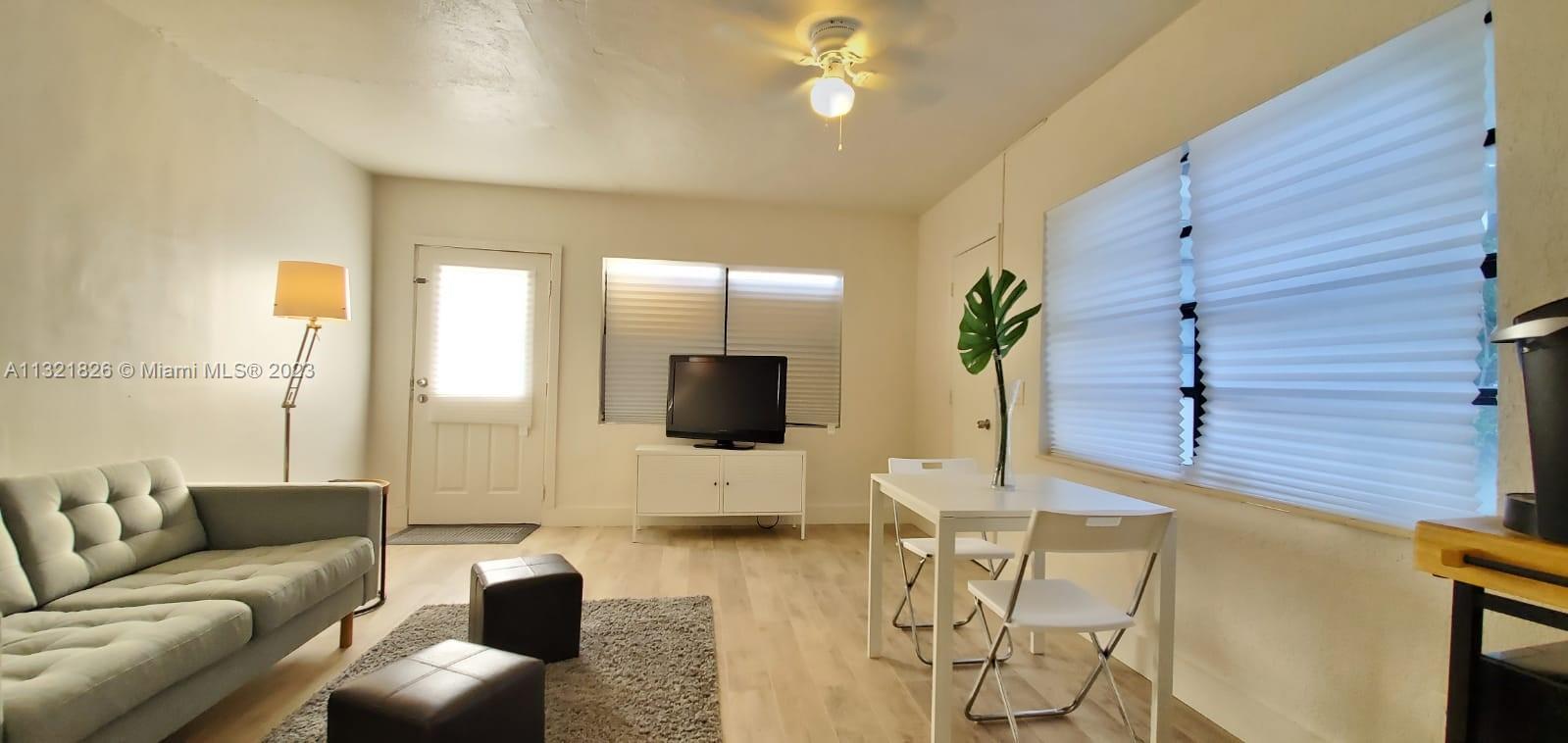 275 Northwest 46th Street, Unit B Miami, FL 33127 - Photo 4 of 9 a living room with furniture and a flat screen tv