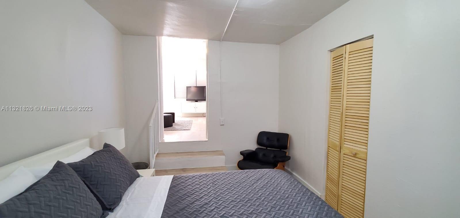 275 Northwest 46th Street, Unit B Miami, FL 33127 - Photo 5 of 9 a bedroom with a bed and a window