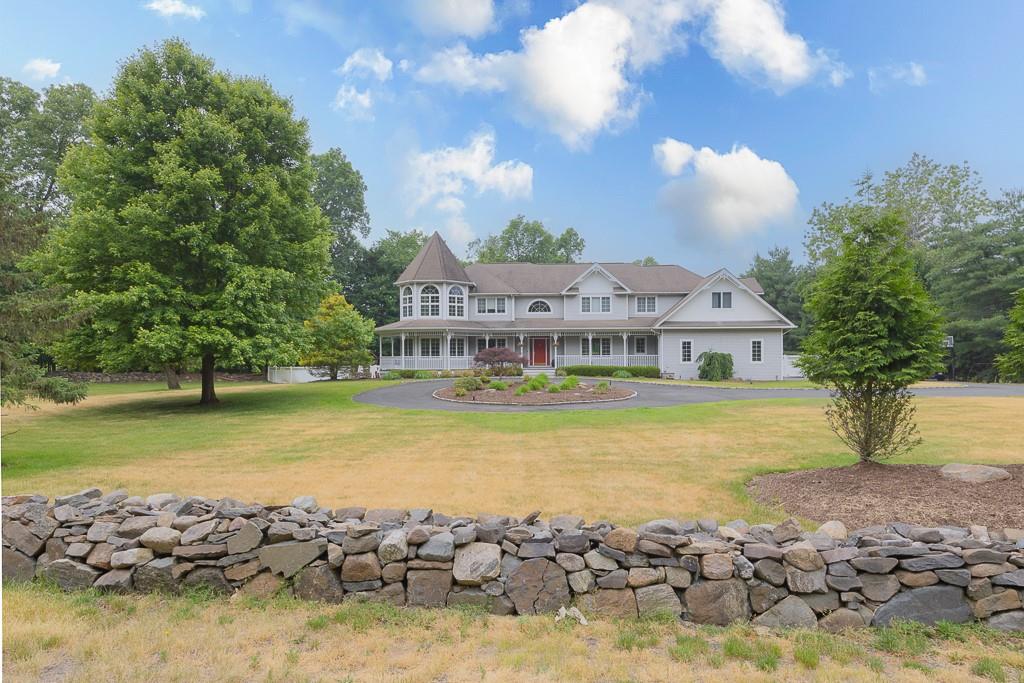 a view of an ocean with trees and houses in the back